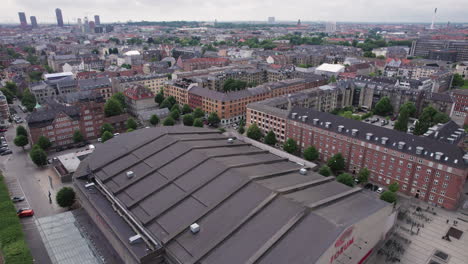 looking down from above, you'll see the forum building immersed in the vibrant city atmosphere, encircled by buildings and cars