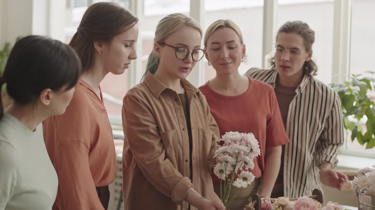 Woman with Flowers Talking to Colleagues