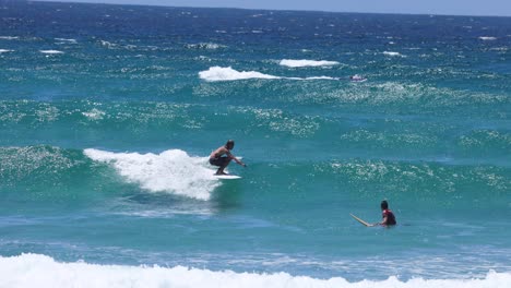 sequence of a surfer catching and riding a wave