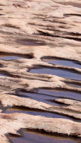 water flowing over eroded sandstone rock bed