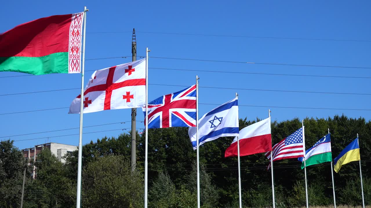 Flags of Belarus, Georgia, Great Britain, Israel, Poland, USA, Uzbekistan and Ukraine on flagpoles