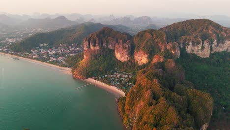 take in a breathtaking wide aerial view of the stunning mountains surrounding ao nang beach in krabi. the dramatic landscape and crystal-clear waters create a perfect blend of natural beauty.