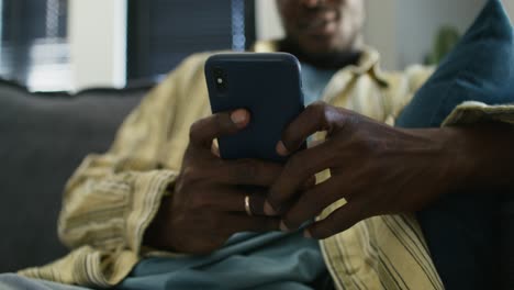 man using a smartphone at home
