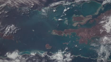 aerial shot of tropical islands and ocean seen from orbit