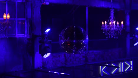 nightclub interior with disco ball and chandelier