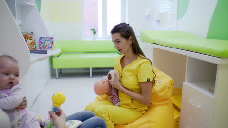 doctor teaching baby feeding. doctor teaching mother to breastfeed her baby