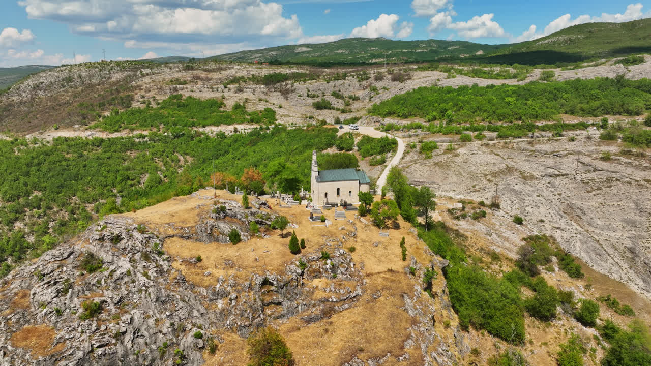 Aerial view circling the Crkva Na Valu Vracenovici church, summer in Montenegro