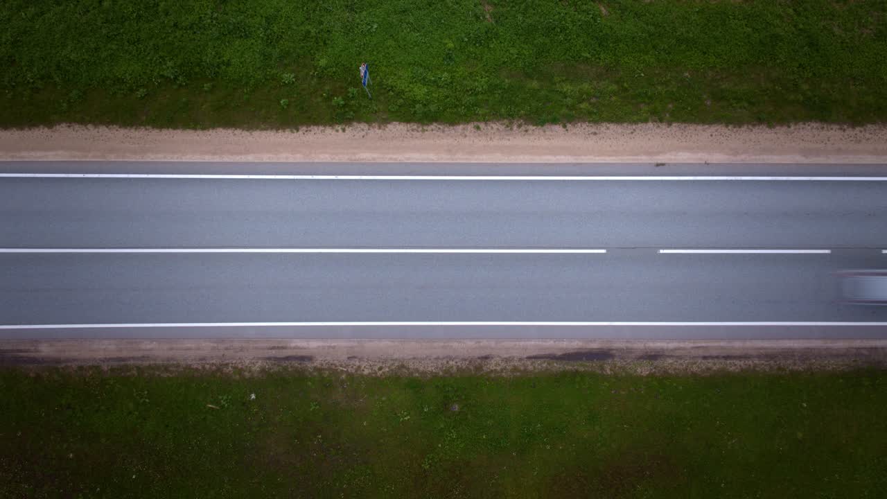 Top down timelapse with cars in motion blur speeding on highway in Latvia
