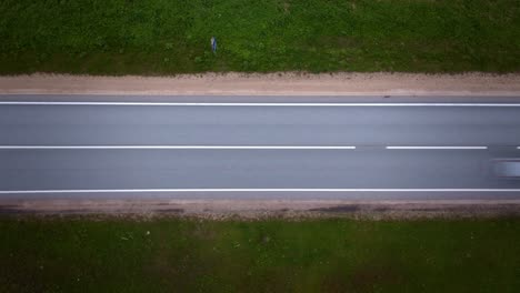 top down timelapse with cars in motion blur speeding on highway in latvia
