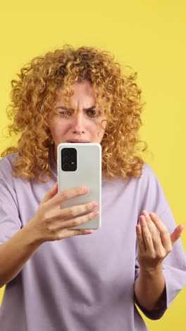 woman reacting to smartphone with shock, frustration, and distress
