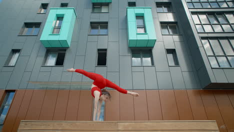 woman performing acrobatics on balcony