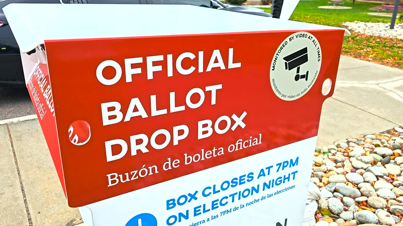 A sturdy outdoor mail-in ballot drop box marked “Official Ballot Drop Box” and “Buzón de Boleta Oficial,” providing voters a safe, official, and convenient way to submit election ballots by mail