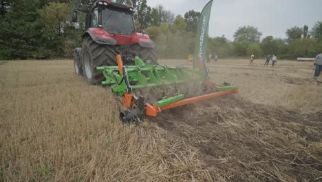 demonstration of agricultural machinery at an exhibition. tractors operate in the field, showcasing their capabilities and performance in action