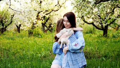 mother and child are hugging and having fun outdoor in nature