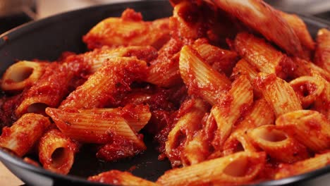 cooking penne pasta with tomato sauce