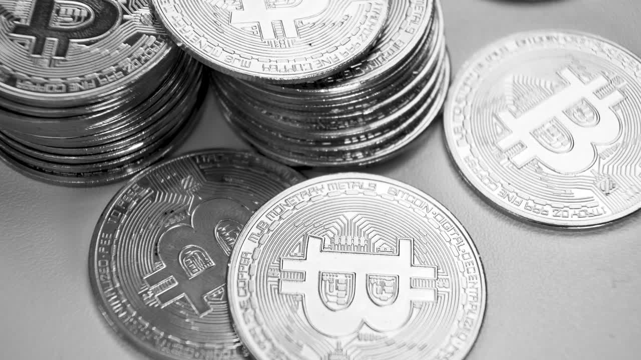 bitcoins en blanco y negro en montones, video inclinado de 4k, monedas criptográficas