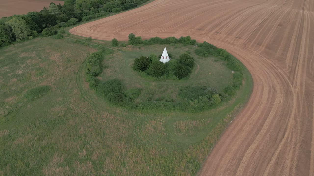 Aerial view approaching Farley mount monument horse burial marker on Hampshire country park hill