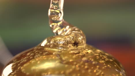 Golden-glue-spiral-coming-out-forming-globs-macro-isolated