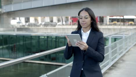 concentrated businesswoman with tablet pc outdoors