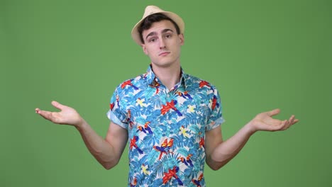 Young handsome tourist man choosing between left and right