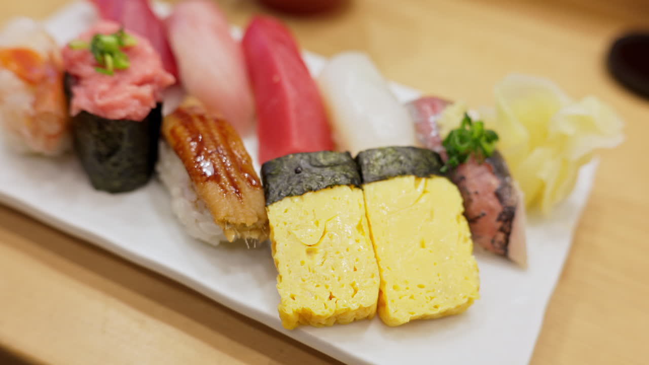 Close up of nigiri on a white plate at the Tsukiji Fish Market in Japan