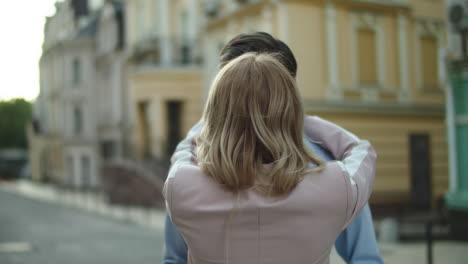 closeup couple standing together at date outside. young business couple hugging