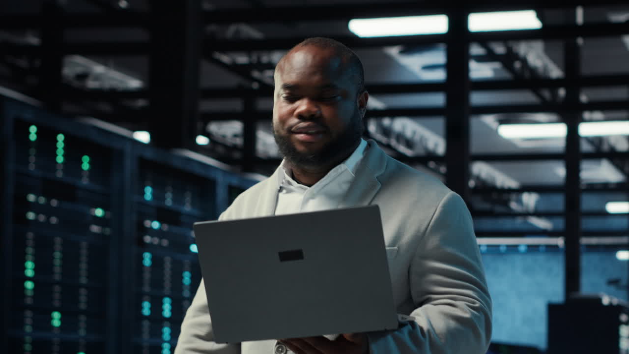 Vertical video Data center computer scientist using laptop to manage system stability