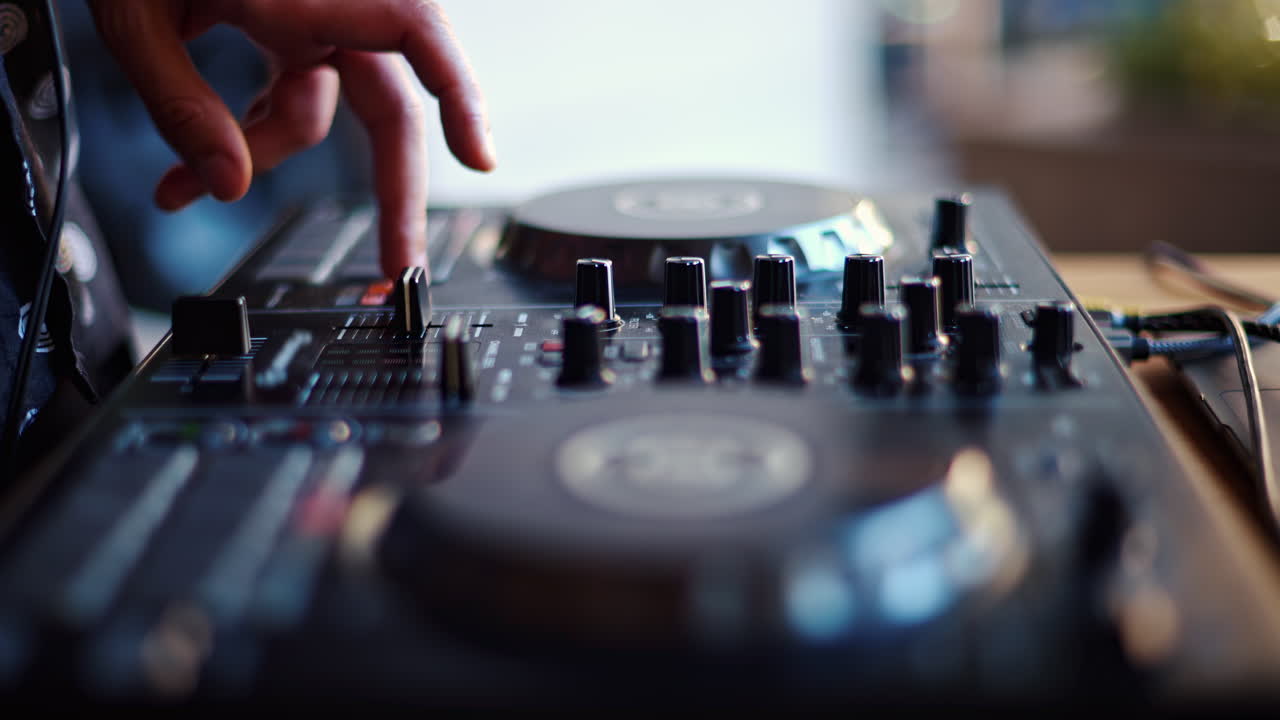 Close up of a woman touching the buttons of a DJ controller