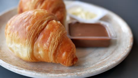 croissants with butter and chocolate sauce