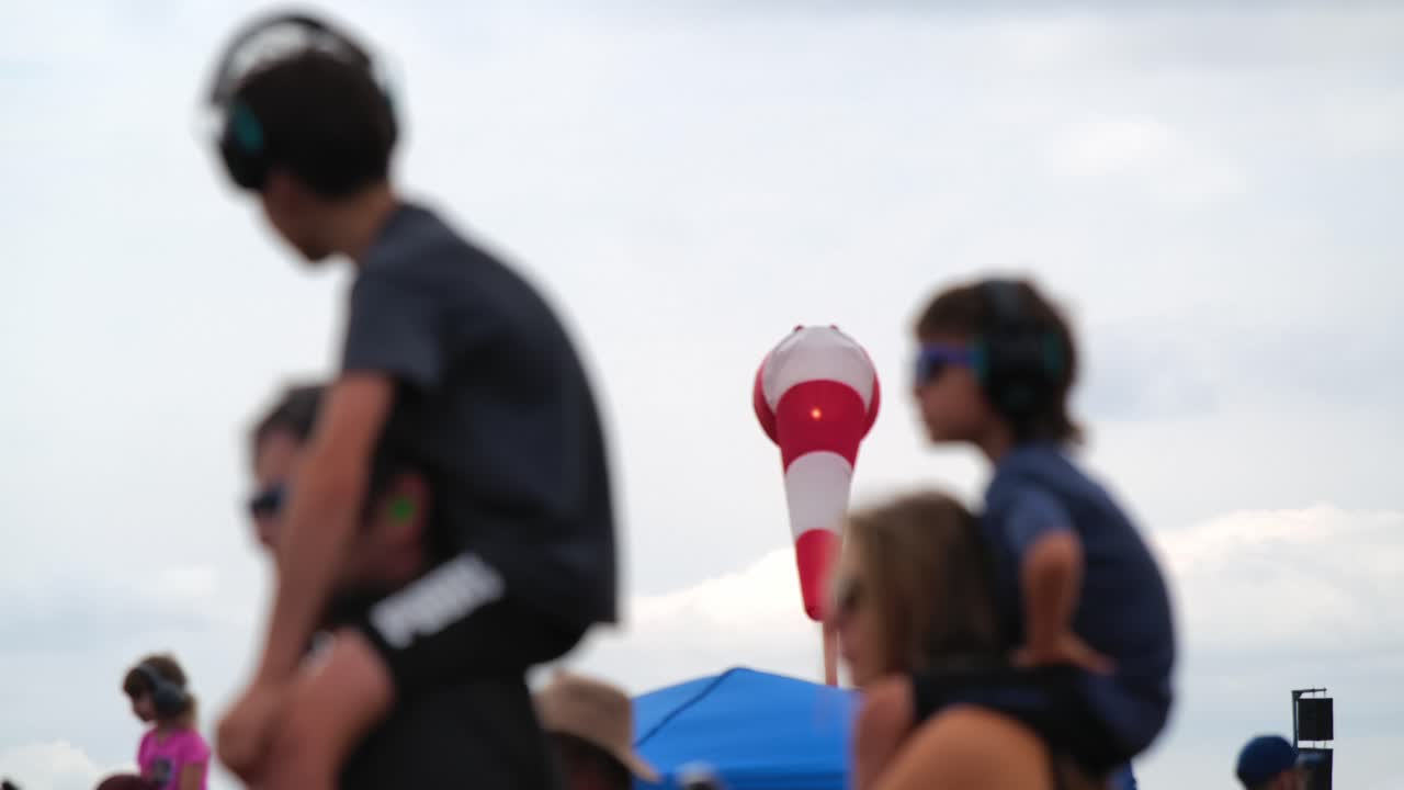 Family at a Music Festival with a Windsock in the Background