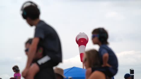 family at a music festival with a windsock in the background