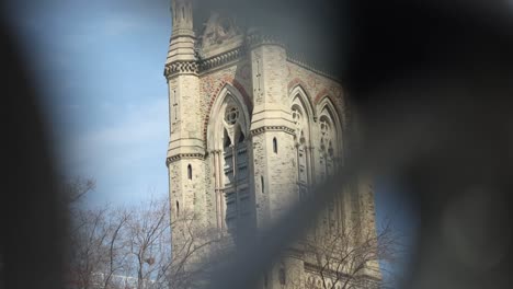 west block parliament building through the steel gate of the surrounding walls in ottawa, ontario