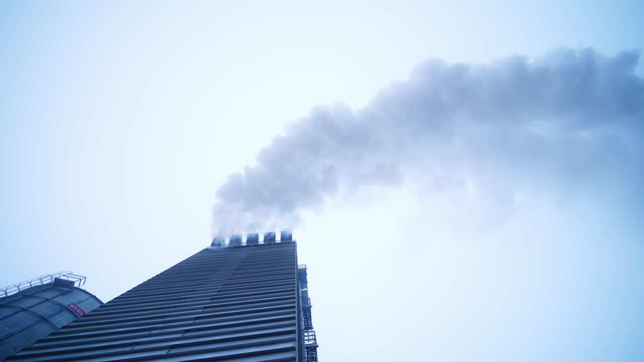 White puffs of smoke from a modern heating stove. Elevator heating system smoking.