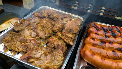 Grilled-Smoked-Seasoned-Meat-And-Sausage-Placed-On-The-Aluminum-Foil-Topper-Pan---High-Angle-Shot