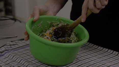 Mixing Asian roll ingredients in a bowl before assembly