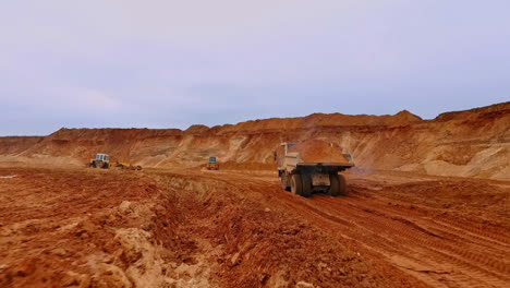 Tipper-truck-carries-sand.-Drone-view-of-dump-truck-transporting-sand-on-quarry