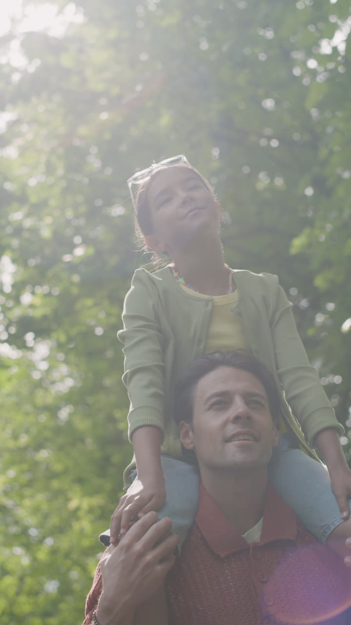 Father and Daughter Piggyback Ride in the Park