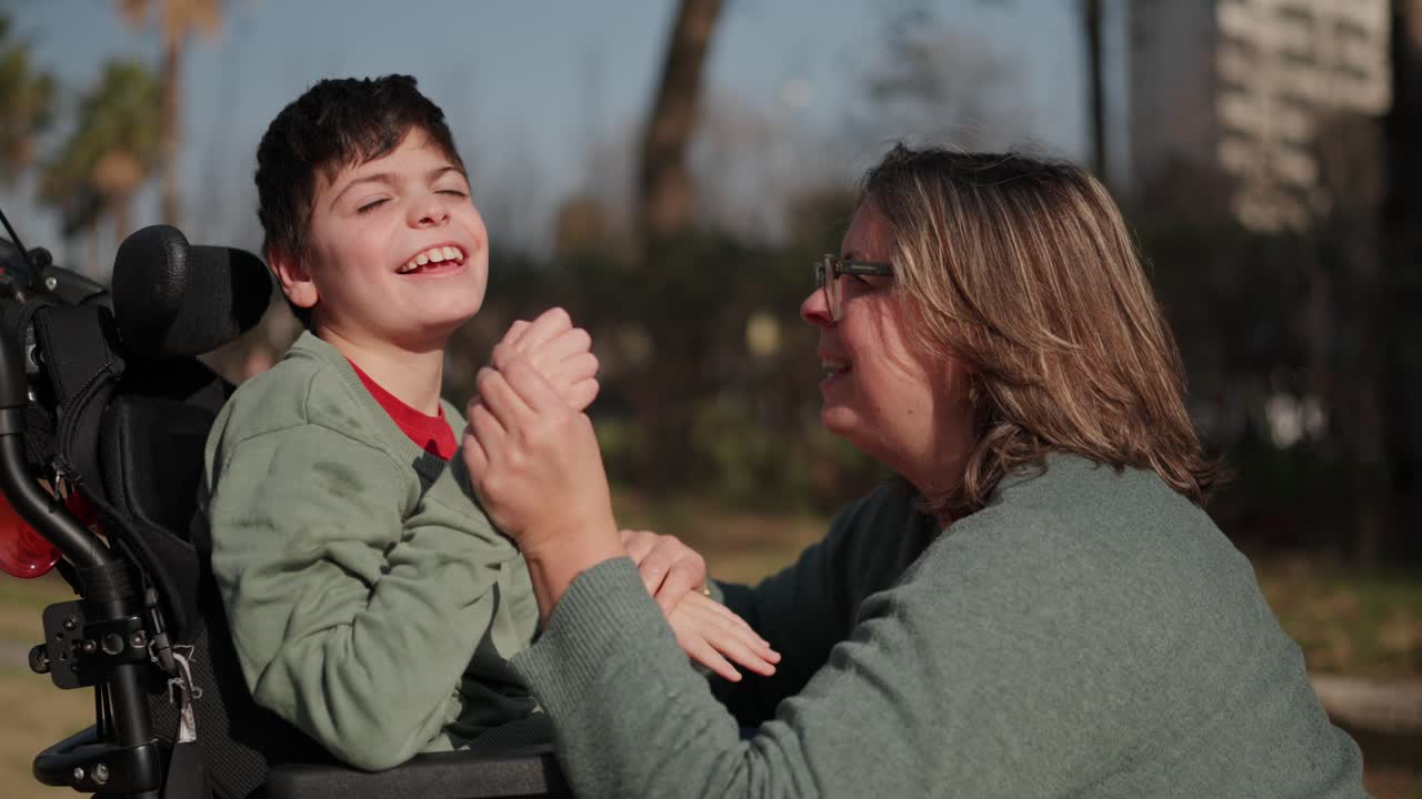 A mother and son sharing a moment in his wheelchair
