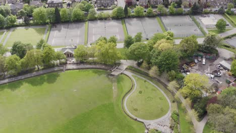 Aerial-drone-shot-flying-over-English-tennis-courts-in-rural-countryside-town