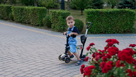 toddler riding a scooter in a park