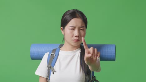 woman with backpack pointing
