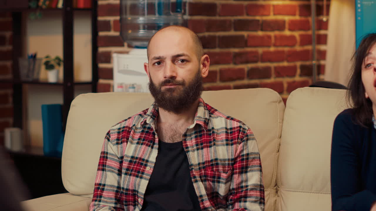 Portrait of displeased man talking about marriage with counselor