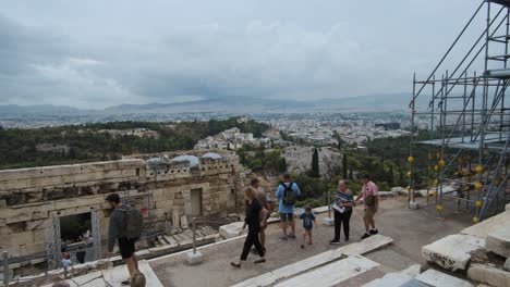 athens, greece - october 12, 2021: a crowd of tourists storm the acropolis after its opening. propylaea gateway in background