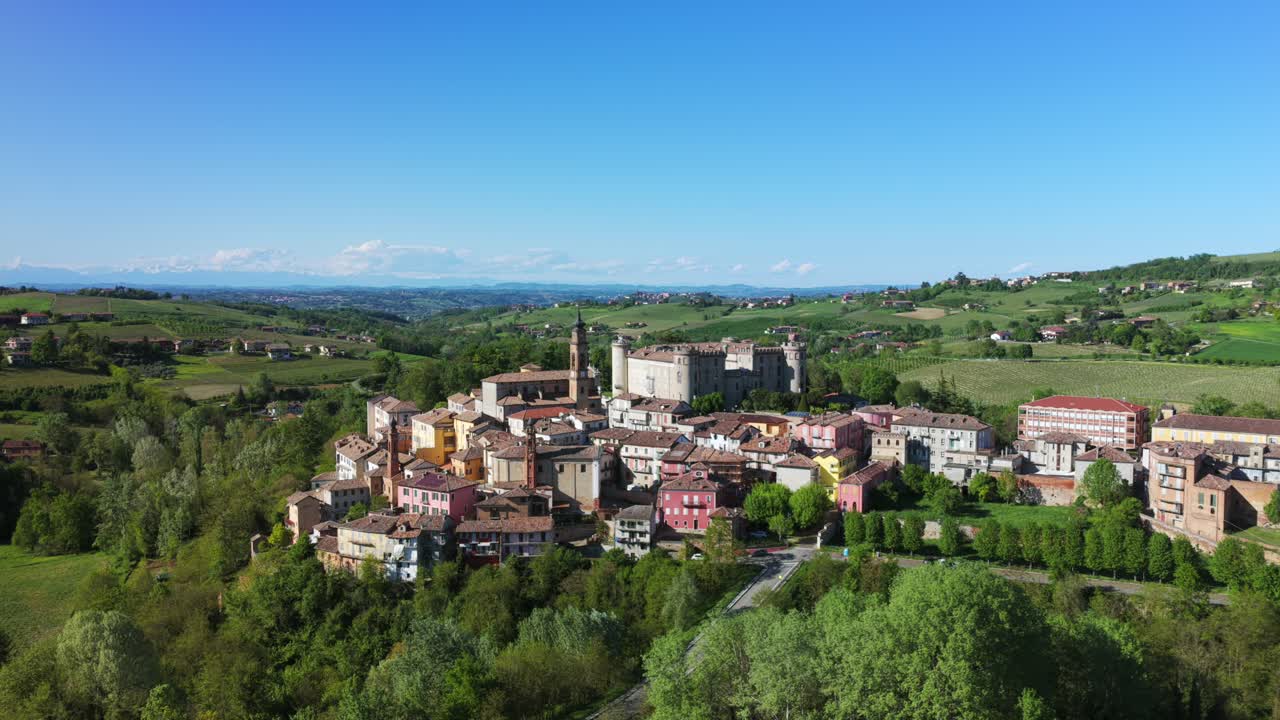 Scenic Aerial View Of Costigliole d'Asti - Italian Town With Historic Buildings And Lush Vineyards On Hills. ascending drone shot