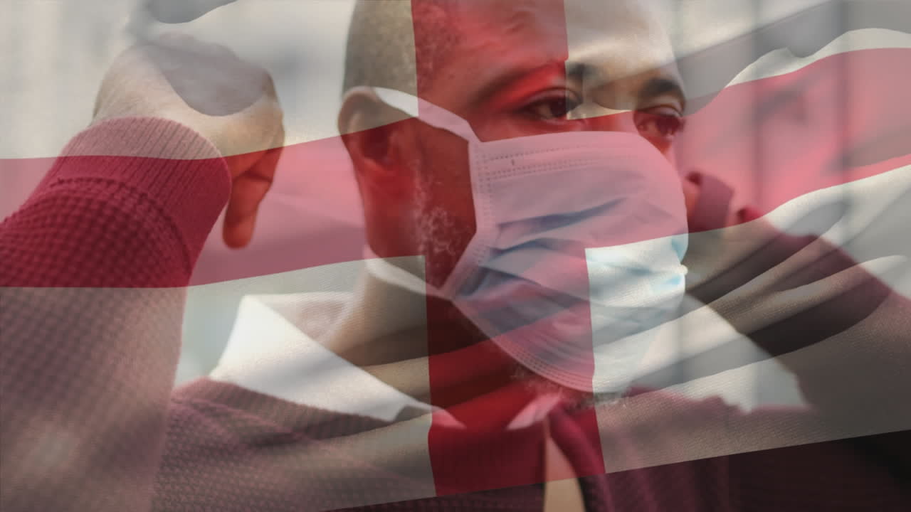 animación de la bandera de inglaterra ondeando sobre un hombre que usa una máscara facial durante la pandemia de covid-19