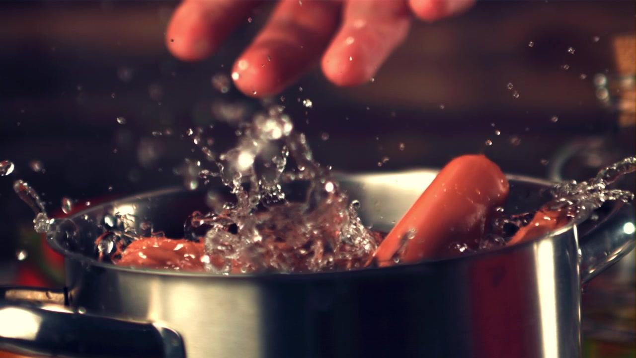 Sausages Dropping into Boiling Water in Slow Motion