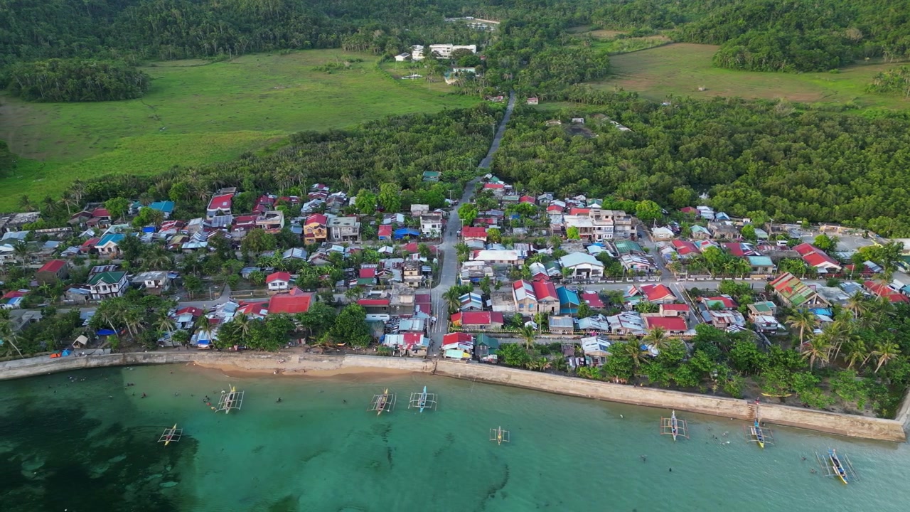 Cảnh nhìn từ trên cao của Magnesia Del Norte ở Virac, Catanduanes với những ngôi nhà ven biển, thuyền bangka đánh cá, nước rạn san hô và những ngọn đồi nhiệt đới