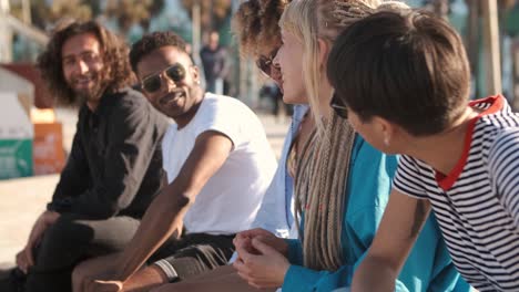 Happy-young-diverse-people-chatting-in-leisure