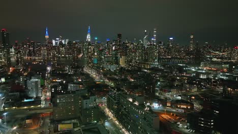 an aerial view high over long island city, new york at night