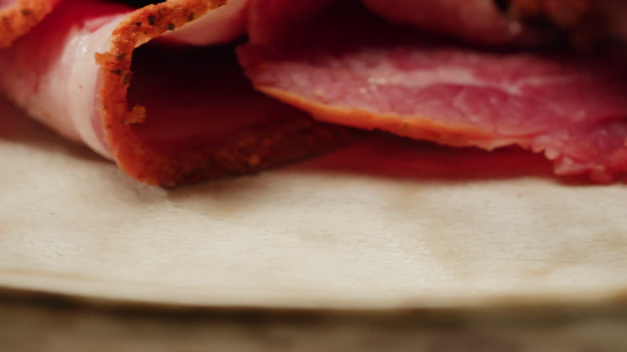 Close-up of sliced cured meat on a plate
